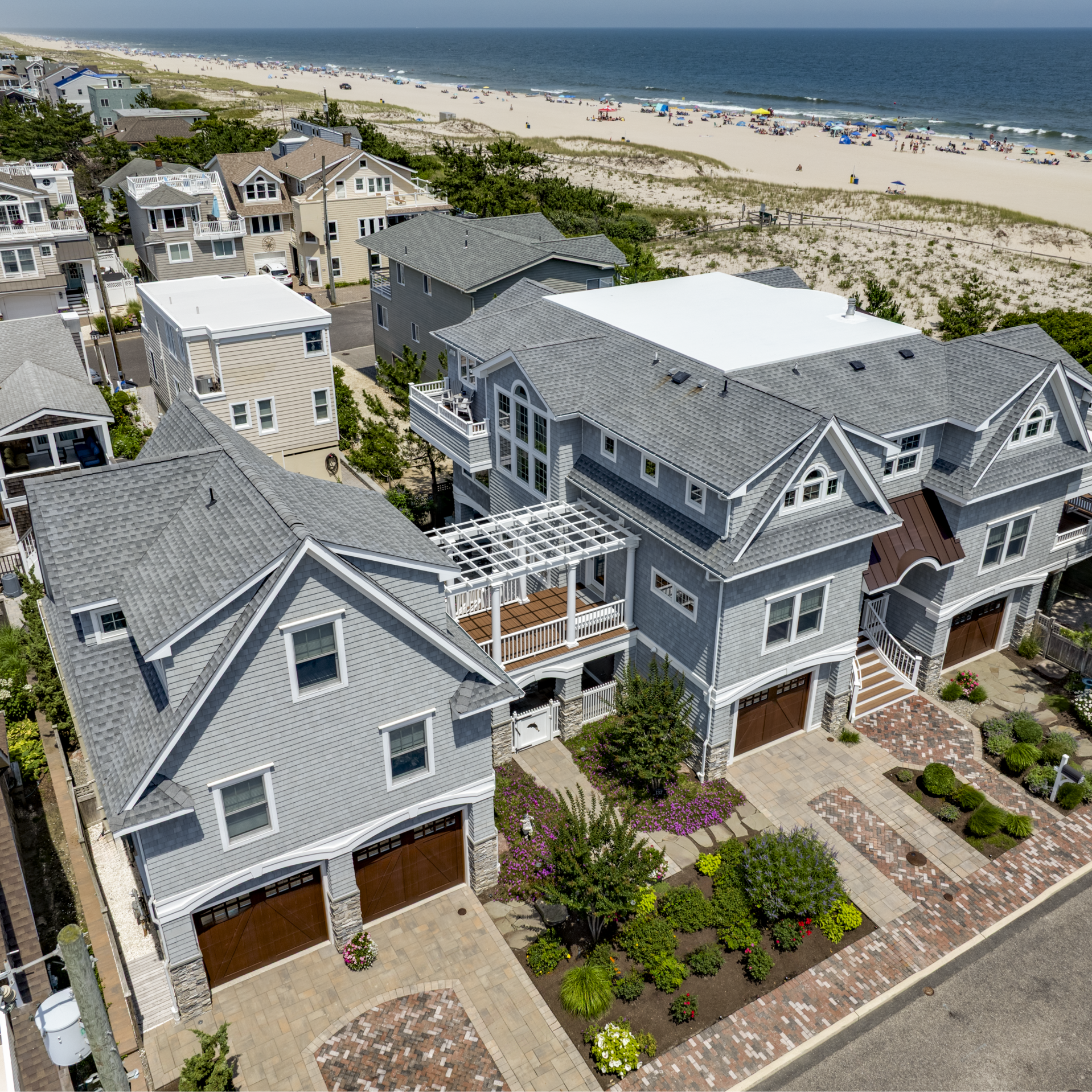 Exterior of a luxury custom home on LBI featuring coastal design, in-law suite, and beautiful landscaping | Stonehenge Built | LBI Custom Home Builder